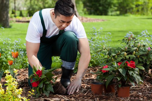 Gardener wearing full PPE preparing tools before work